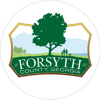 Forsyth County logo with a tree and grassy background and forsyth written in front of the tree